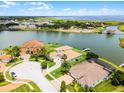 Beautiful aerial view of waterfront houses with tile roofs, green lawns, and boat docks at 1110 Terralago Way, Kissimmee, FL 34746