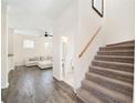 Open-concept living room with hardwood floors, a staircase, a half-bath, and comfortable furniture at 121 Longview Ave, Celebration, FL 34747