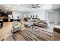 Open concept living room featuring neutral colors, ceiling fan, and tile flooring at 1614 Lima Ave, Kissimmee, FL 34747