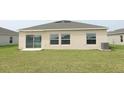 Expansive backyard with lush green grass and sliding glass doors leading inside at 165 Citrine Loop, Kissimmee, FL 34758