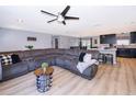 Open-concept living area with a large sectional sofa and modern decor, seamlessly flowing into the kitchen at 1730 Carolyn Ct, St Cloud, FL 34769