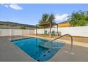 Beautiful private pool area with tanning deck and pergola with seating, perfect for outdoor relaxation and entertainment at 2060 Patriot Way, St Cloud, FL 34769