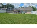 Expansive backyard featuring a screened-in pool and ample green space at 215 Grovepark Dr, Davenport, FL 33837