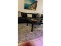 Comfortable living room featuring a plush sofa, decorative pillows, and stylish coffee table decor at 2203 San Vittorino Cir # 103, Kissimmee, FL 34741