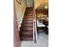 Entryway with wood stairs leading to a kitchen area featuring a breakfast bar at 2289 Seven Oaks Dr, St Cloud, FL 34772