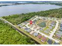 Aerial view of a neighborhood showcasing a home near a lake, pond, and canal at 233 E Cattail, Lake Alfred, FL 33850