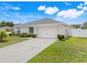 Charming single-story home features a well-manicured lawn and attached two car garage at 233 E Cattail, Lake Alfred, FL 33850