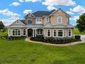 Beautifully designed two-story home with stone accents, a landscaped front yard, and a brick walkway at 2350 Bradbury Rd, Haines City, FL 33844