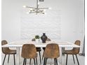 Modern dining room with decorative lighting, textured wall art, and seating for six at 2605 Scrapbook St, Kissimmee, FL 34746