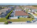 Aerial view of a neighborhood showcasing the backyard, fencing, pool enclosures and proximity to other homes at 307 Fox Loop, Davenport, FL 33837