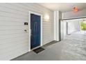 Condo entrance featuring a dark blue door, sidelight, door bell, security system, and unit number at 3175 Feltrim Pl # 101, Kissimmee, FL 34747