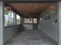 The carport boasts a wooden plank ceiling and floral decorations at 320 S Seminole Ave, Lake Alfred, FL 33850