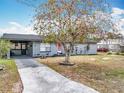 Quaint single-story home with a driveway and attached carport, offering convenience and curb appeal at 320 S Seminole Ave, Lake Alfred, FL 33850