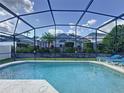 Refreshing screened-in pool, perfect for relaxation and outdoor enjoyment with manicured landscaping at 4707 Pershoie Ln, Kissimmee, FL 34746