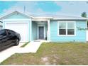 Lovely light blue single-story home with a one-car garage and a concrete driveway on a sunny day at 5506 Glen Lake Ln, Orlando, FL 32808