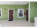 Condo entrance featuring a brown door, a window with blinds, and green siding at 607 Gran Bahama Blvd # B29/U607, Davenport, FL 33897