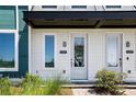 Entrance of townhome with white door, modern fixtures, and craftsman details at 6501 Cyrils Dr, St Cloud, FL 34771
