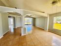 Spacious living room with tile flooring, column accents, and sliding doors leading to the backyard at 664 Eagle Pointe S, Kissimmee, FL 34746
