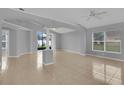 Expansive living room showcasing tiled floors, a decorative ceiling, and abundant natural light at 664 Eagle Pointe S, Kissimmee, FL 34746