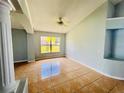 Bright living room with tile floors, large windows, and a ceiling fan at 664 Eagle Pointe S, Kissimmee, FL 34746
