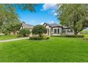Charming home with mature trees, lush lawn, and a brick driveway at 6761 Valhalla Way, Windermere, FL 34786