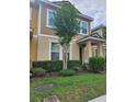 Inviting two-story townhome with a well-maintained lawn and mature tree providing shade and curb appeal at 7673 Ripplepointe Way, Windermere, FL 34786