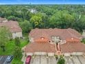 Aerial view of condos featuring tile roofs, lush greenery, and manicured lawns create an inviting community at 7865 Sugar View Ct # 7865, Orlando, FL 32819