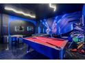 Basement game room featuring a pool table, Foosball table, Star Wars decor, and multiple wall-mounted screens at 9020 Stinger Dr, Davenport, FL 33896