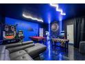 Unique basement game room with a pool table, foosball table, vintage arcade games, and creative decor at 9020 Stinger Dr, Davenport, FL 33896
