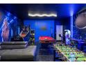 Fun basement game room featuring arcade games, a foosball table, Star Wars decor, and stylish blue lighting at 9020 Stinger Dr, Davenport, FL 33896