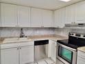 Bright kitchen featuring white cabinetry, stainless steel appliances and durable countertops for cooking and food prep at 9916 Sweepstakes Ln # 7, Orlando, FL 32837