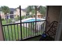 View of the community pool area and well-manicured grounds from the screened in patio at 9916 Sweepstakes Ln # 7, Orlando, FL 32837
