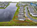 Aerial view of home with waterfront backyard and lush landscaping at 10364 Shive Island Ct, Orlando, FL 32827