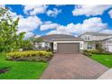 Charming single-Gathering home boasts a well-manicured lawn, lush landscaping, and an attached two-car garage at 10364 Shive Island Ct, Orlando, FL 32827