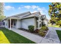 Charming single-story home with a well-manicured lawn and mature landscaping at 11730 Kennington Ct, Orlando, FL 32824