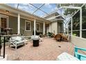 Screened in patio with brick pavers and plenty of comfortable seating with overhead covering at 1321 Artisan E Ave, Celebration, FL 34747