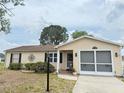 Inviting single-story home with an attached garage, neutral siding, and established landscaping in the front yard at 1410 Sanchez Ct, Lady Lake, FL 32159