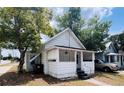 A cozy cottage-style home with a covered porch and mature trees at 1413 11Th St, St Cloud, FL 34769
