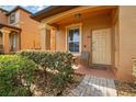 Charming front entrance with covered porch and lush landscaping at 203 La Mirage St, Davenport, FL 33897