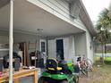 Rear exterior featuring lawn equipment, storage, and access to the home's backyard at 2329 W Doris St, Kissimmee, FL 34741