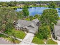 Scenic aerial view of a single Gathering home with a large front yard and a serene lake in the background at 248 Country Landing Blvd, Apopka, FL 32703