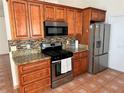 Well-equipped kitchen features stainless steel appliances and granite countertops at 260 Piccolo Way, Davenport, FL 33896