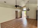 Open-concept living area boasts tile flooring, high ceilings, and natural light at 260 Piccolo Way, Davenport, FL 33896