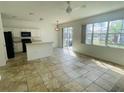 Bright eat-in kitchen with white cabinets, modern appliances, and large windows offering lots of light at 2728 Portchester Ct, Kissimmee, FL 34744