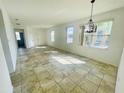 Bright living room featuring tile flooring and ample natural light from multiple windows at 2728 Portchester Ct, Kissimmee, FL 34744