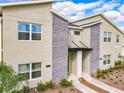 Modern townhome exterior with stone facade and contemporary design details in a well-maintained community at 2970 Protagonist St, Kissimmee, FL 34746