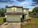 Two-story home featuring an attached two-car garage, neutral color scheme and well-maintained landscaping at 320 Southern Winds Blvd, Deland, FL 32720