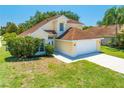 Charming two-story home with a well-manicured lawn and attached two-car garage at 3203 Herons Point Cir, Kissimmee, FL 34741