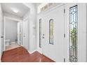 Bright foyer featuring wood floors, a decorative front door, and white trim at 3203 Herons Point Cir, Kissimmee, FL 34741