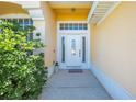 Charming front entrance with a decorative white door and manicured shrubbery at 3203 Herons Point Cir, Kissimmee, FL 34741